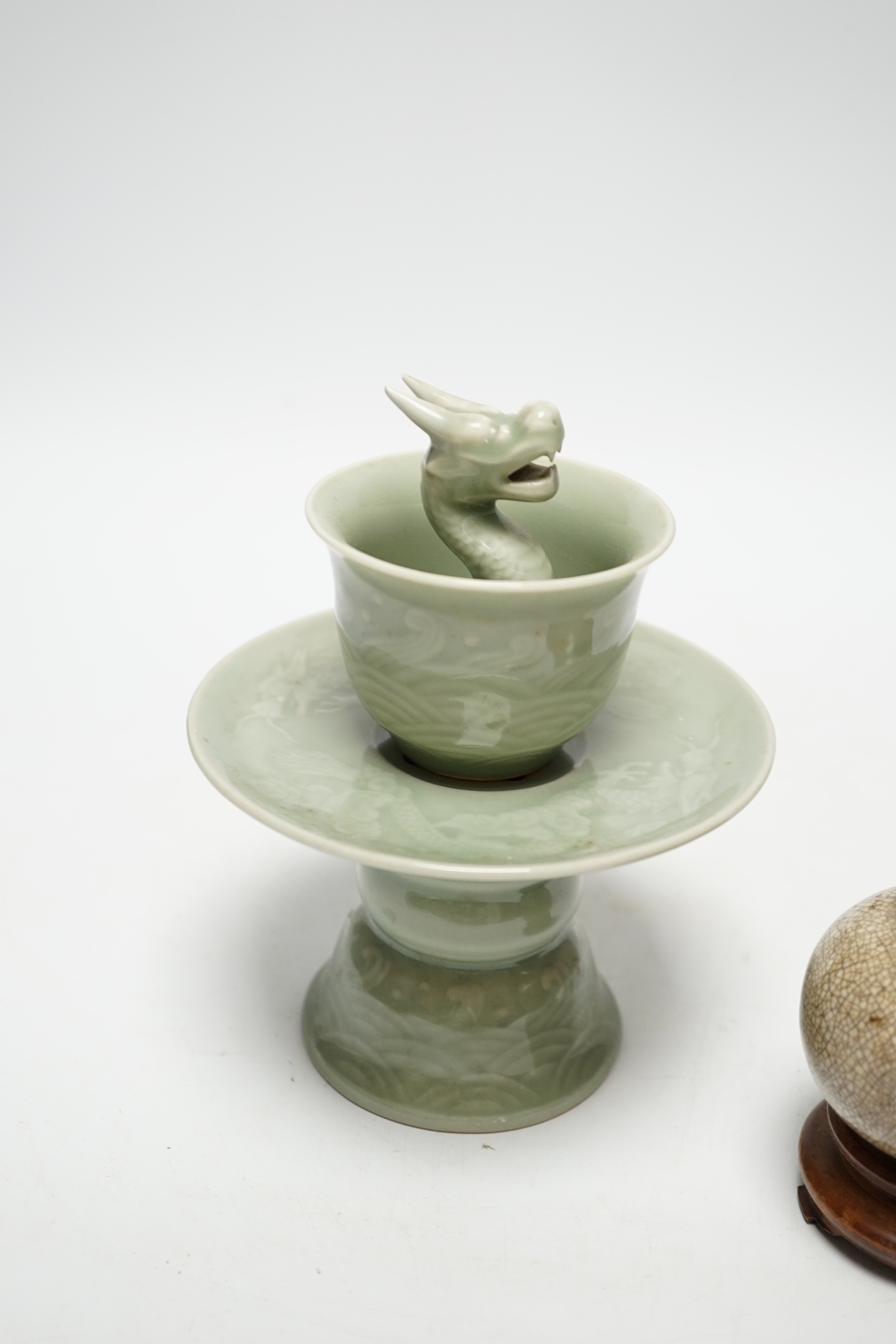 A Chinese celadon glazed 'dragon' puzzle cup and stand, early 20th century and a Chinese crackle glaze vase, 19th century, cup 7.5cm